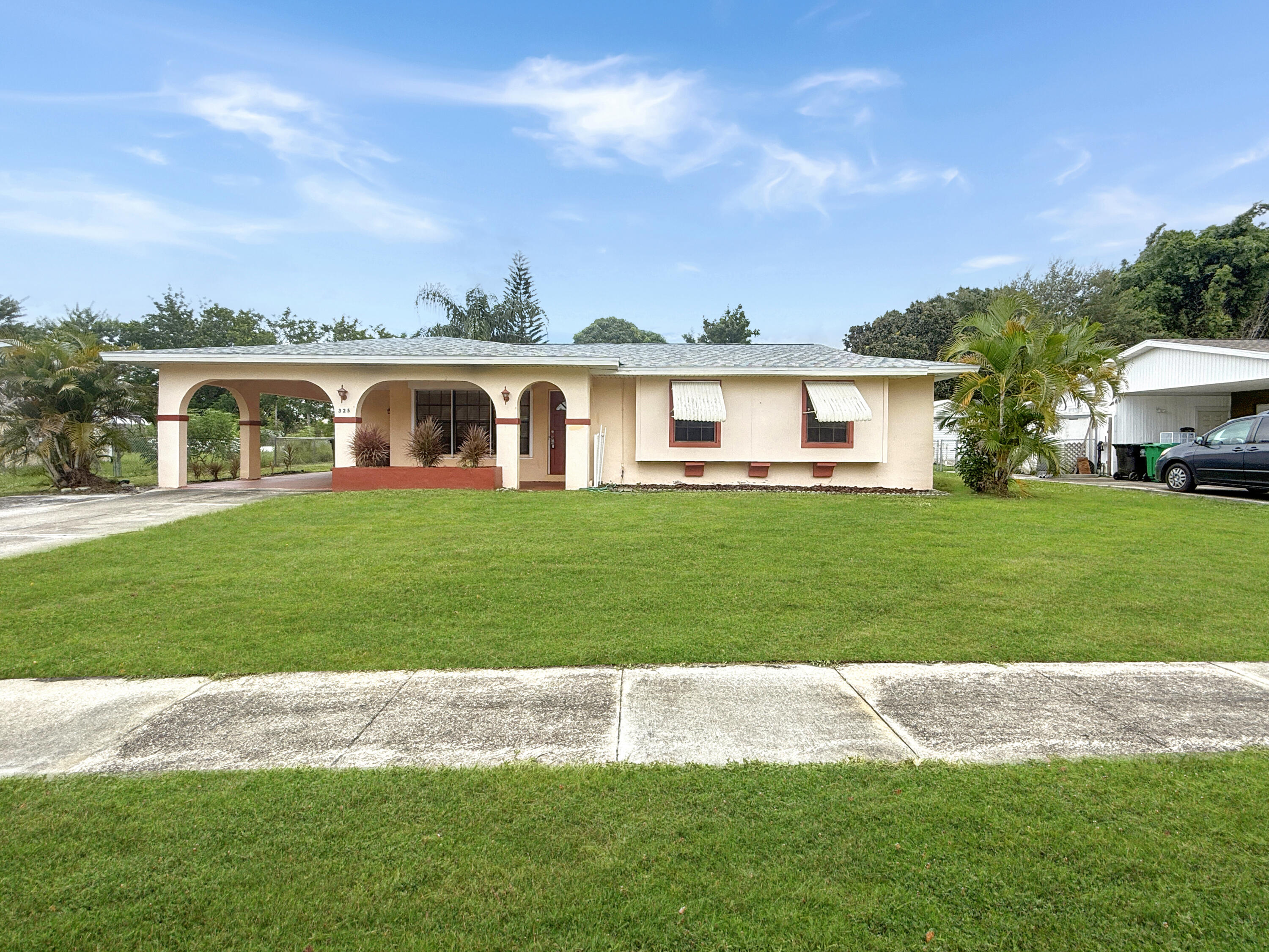 Welcome to 325 NE Orchard St in Port St. Lucie! This beautifully maintained home offers 3 spacious bedrooms, 2 baths, and an open-concept layout with tile floors and plenty of natural light. The modern kitchen features stainless steel appliances and ample granite counter space. Enjoy a private fenced backyard perfect for relaxing or entertaining. Additional highlights include a carport, washer/dryer in the laundry room, and central A/C. Conveniently located near parks, schools, shopping, dining, and just minutes from major highways for an easy commute.
