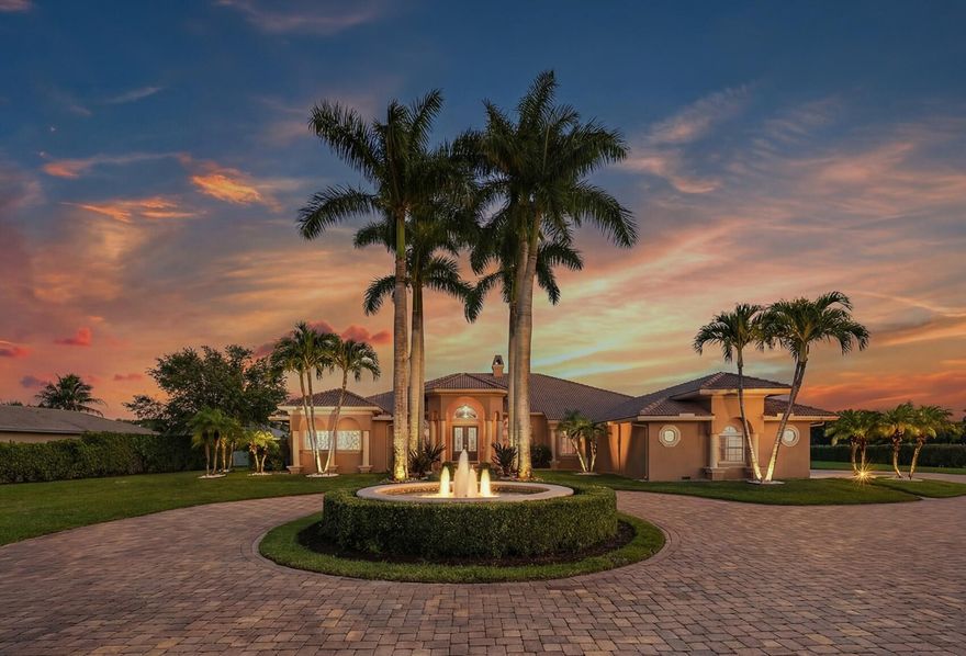 An exceptional opportunity in Paddock Park II—two separately listed parcels totaling 3.81 acres. The primary 1.8-acre estate features 5,000+ sq ft with soaring ceilings, 5 bedrooms, home gym, and billiards room, plus a renovated oversized saltwater pool and spa, hurricane-impact windows, and luxurious high-end finishes throughout. Perfect for entertaining, the home seamlessly blends indoor-outdoor Florida living. Backing a serene canal and within hacking distance to the bridle path, the property offers privacy, lifestyle, and equestrian potential. The adjacent vacant parcel is ideal for a custom barn, arena, guest house, or private compound. Conveniently located near Wellington's premier showgrounds, world-class shopping, fine dining, and beautiful South Florida beaches. The home has been meticulously updated with high-end features and modern conveniences, including new kitchen appliances (2020) and refrigerator (2022), impact windows and doors (2025 & 2023), a renovated oversized saltwater pool with new heater (2023 & 2026), and a 60k whole-house generator (2023). Additional enhancements include a new Lennox HVAC system (2023), Culligan reverse osmosis water system (2025), garage floor performance coating (2025), new gate system (2022), fountain resurfacing (2023), and a new washer and dryer (2025)—ensuring comfort, reliability, and turnkey luxury throughout. One bedroom is utilized as home office/den, can easily be converted back to bedroom.