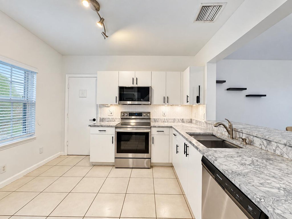 Photo of 9491 Stanley Lane, Tamarac, FL 33321 (MLS # B26078168)