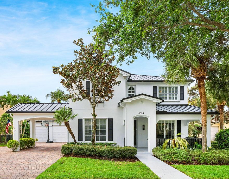 Welcome to an exceptional residence in the highly sought-after VillageWalk community of Wellington, where resort-style amenities and scenic surroundings create an unmatched lifestyle. Centered around 112 acres of a stunning lake views with charming bridges and winding canals, VillageWalk offers residents a vibrant town center with a café, resort-style pool, lap pool, fitness center, tennis and pickleball courts, basketball, bocce ball, playground, and miles of picturesque walking paths. Situated on a private cul-de-sac, this impressive two-story home offers 3,451 square feet of beautifully maintained living space. The home immediately captivates with a quaint front porch, brand-new black metal roof and fresh exterior paint (2025), delivering striking curb appeal.    A three-car garage and extended driveway with carport provide abundant parking for family and guests. The spacious fenced backyard is a private retreat, complete with new sod, landscape lighting, a resurfaced freeform pool and patio, sunshade awning, and a covered screened lanai overlooking a tranquil canal view—perfect for relaxing afternoons or elegant outdoor entertaining. Inside, the thoughtfully designed floor plan offers both comfort and versatility. A welcoming front porch opens to multiple living spaces including a living room with electric fireplace, formal dining room, family room, private office, and a bright eat-in kitchen nook. The open-concept kitchen and family room create a warm gathering space and feature new stainless-steel appliances, abundant cabinetry, and seamless views to the pool and backyard through sliding glass doors. Upstairs, the luxurious primary suite is filled with natural light and offers two oversized walk-in closets and a private balcony, creating the perfect owner's retreat. All three upstairs bathrooms have been beautifully updated with new flooring, showers, tubs, and countertops. Additional highlights include crown molding, a first-floor bedroom with adjacent full bath, ideal for guests or multigenerational living, a first-floor office, and a full laundry room with utility sink and ample storage. Extensive recent upgrades ensure peace of mind and modern comfort, including: • New metal roof and exterior paint (2025) • Two A/C systems (2020) • Two water heaters (2026) • Pool resurfacing with new pump and filter (2025) • New stainless steel kitchen appliances (2025) • New luxury vinyl flooring (2025) • Professionally resurfaced garage floor with added storage cabinetry • New outdoor lighting (2025) This remarkable property offers space, elegance, and resort-style living in one of Wellington's most desirable communities.  Schools are wonderfully rated!  Shopping, dining and entertainment all conveniently found nearby.