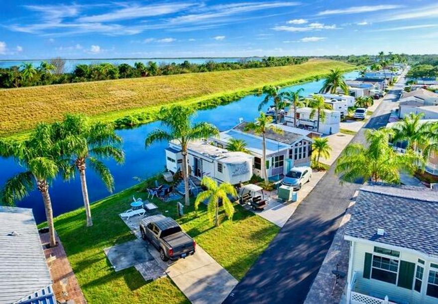 Enjoy winter escapes or full-time retirement at Big O RV Resort. This peaceful waterfront lot is the perfect setting for your RV or park model, offering serene views and a relaxed lifestyle. Located in an active, gated 55+ community, residents enjoy planned activities, on-site management, and an impressive array of amenities, including a heated pool, putting green, shuffleboard, laundry facilities, recreation hall with large screened TV, pool table, basketball court, and a community boat ramp with access to the Rim Canal and Lake Okeechobee. Conveniently located just minutes from shopping, dining, golf courses, and the casino. The adjoining lot is also available for purchase.
