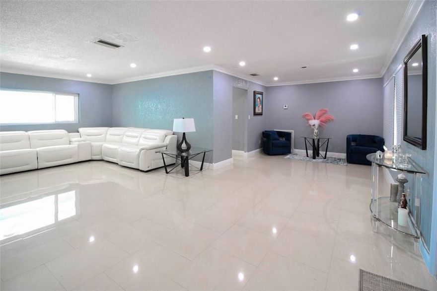 Amazing opportunity to own this renovated 3 bedroom 2 baths 2 car garage home in Royal Palm beach! Lots of living area with this open and spacious floor plan. Beautiful porcelain tile throughout the house, New Impact windows and doors! Very large kithchen with eat in dinning area. Fenced in private backyard with a huge covered patio which is great for entertaining. Great Location! Close to shopping, restaurants, parks.