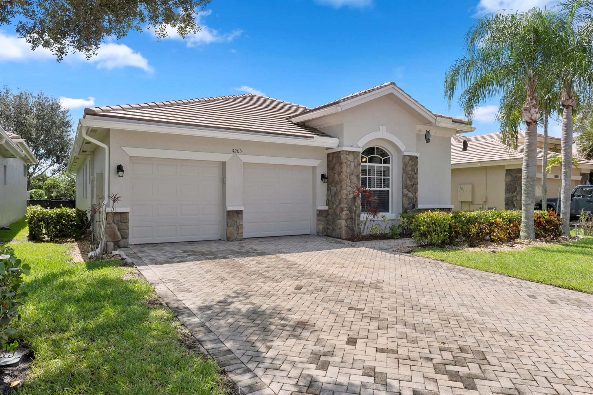 Discover this beautiful single-family home located in the highly desirable neighborhood of Osprey Isles in Palm Beach Gardens. With 4 bedrooms, 3 bathrooms, and an impressive 2,988 square feet of living space, this residence offers plenty of room for you and your family. Nestled in a quiet, family-friendly neighborhood surrounded by nature, yet conveniently close to shopping and the beach, it provides the perfect balance of tranquility and convenience. Step inside and be captivated by the light and airy ambiance created by the 12-foot ceilings throughout the home. The master bathroom features separate sinks, a luxurious tub, and a separate shower. His and her walk-in closets in the master bedroom provide ample storage space.