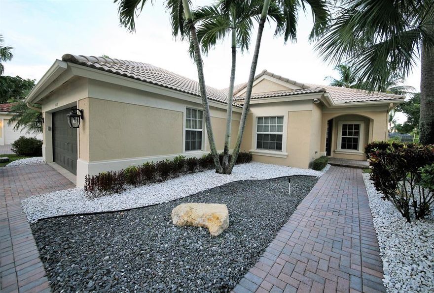 Run to this Mint Model Perfect Home on great wide waterfront lot in gated Parkland Isles. This home features true pride of ownership with 4 bedrooms & 3 full bathrooms & is carpet FREE with beautiful flooring throughout. Enjoy beautiful views from this remodeled eat in kitchen with 42 inch light cabinets, tiled back splash, stainless appliances, granite sink & gorgeous quartz counter tops!. Master bath just remodeled complete with jacuzzi tub & onyx counters. A/c new in 2013, wide crown molding, custom plantation shutters, extended screen enclosure with fabulous wide water views, spacious indoor laundry room, both interior & exterior recently painted, upgraded landscaping & complete with hurricane protection. Enjoy all the clubhouse amenities including pool, tot lot, tennis & more.