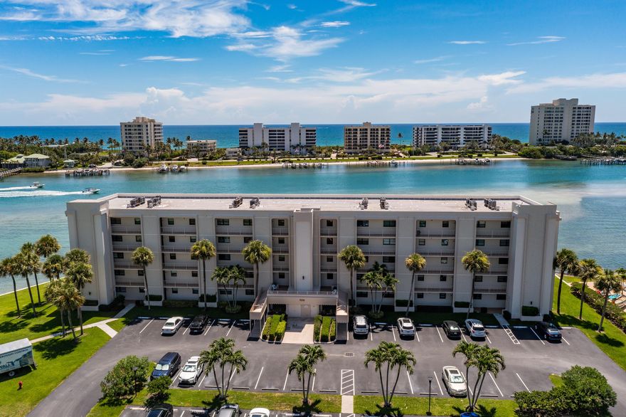This remodeled condo offers breathtaking views of the turquoise waters of the Intracoastal Waterway in Jupiter/Tequesta. Complete with full Impact Glass and Crown Moulding in every room, this unit is freshly painted and offers marble countertops in the kitchen and baths. New AC (2025) and Electrical Panel updated and replaced. The kitchen is open to the living spaces and offers spectacular views. A massive oversized screened patio creates a tranquil oasis overlooking Jupiter Island with direct frontage on the Intracoastal!