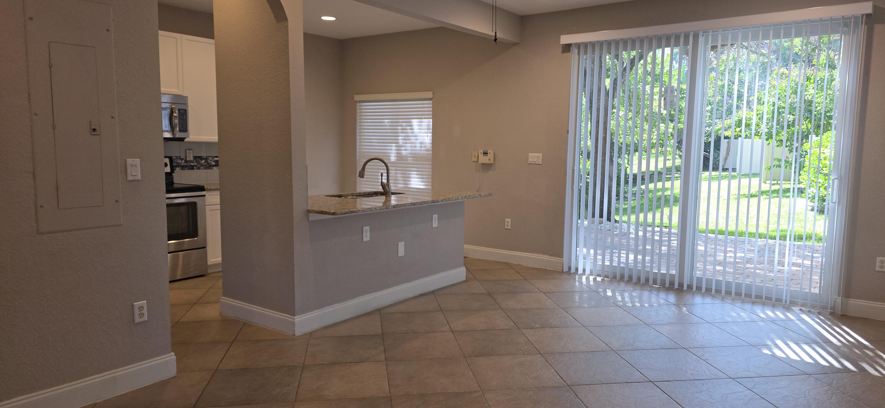 Beautifully updated 3-bedroom, 3-bath corner townhome in Monterey Bay with lake views. Features include a remodeled kitchen with white cabinets, granite countertops, stainless steel appliances, and backsplash; porcelain tile downstairs and wood floors upstairs; impact windows upstairs; and an oversized back patio. The spacious master suite also overlooks the lake. Located minutes from the beach and downtown Delray Beach, with easy access to highways, airports, and more. Enjoy the best of Florida living in this bright, open, and well-appointed home.