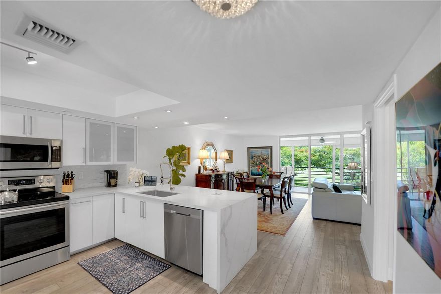Recently renovated King 2-Bedroom unit, the largest 2-bedrooom model in Palm Aire, in pet-friendly, beautifully landscaped and secluded Cypress Grove. This spacious unit offers a huge open concept floor plan, boasting nearly 1400 sq ft of living space. V-shaped 31-ft balcony w/2 sliders offers stunning view of two golf course fairways from the living room and the master bedroom.  Huge open kitchen with newer SS appliances and quartz waterfall. Impact windows in kitchen and guest bedroom. Full-size WD. Stunning Seaview Pine Dune laminate flooring, smooth ceilings and a unique split floor plan. Don't miss out on this incredible opportunity to own a truly exceptional property in Cypress Grove. Pets (max 2) must be no more than 15” in height from the ground to shoulder at maturity.maturity.
