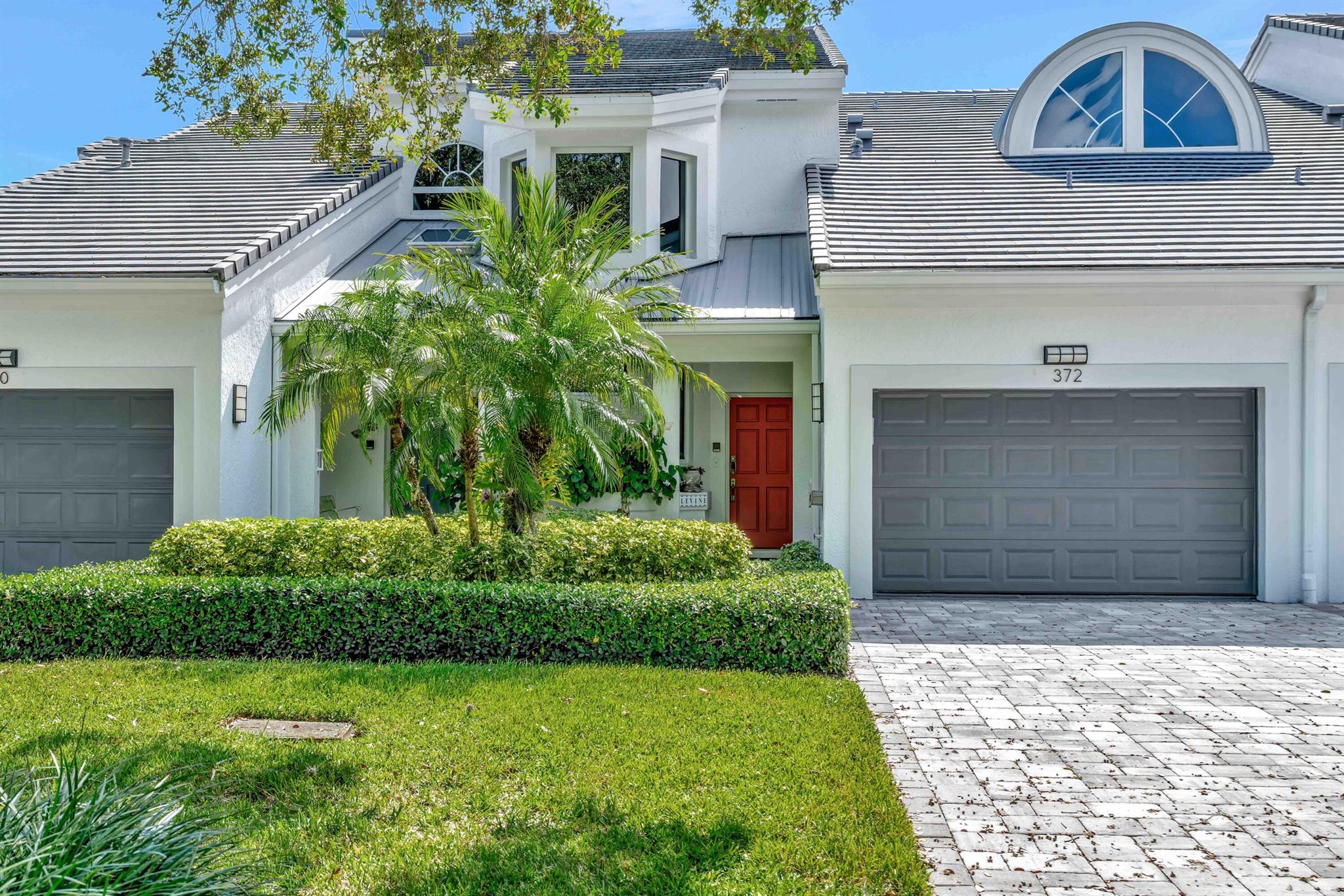 Come home to a beautifully renovated second-floor Harbor Home featuring bright southern exposure and wide water views! This residence offers impact windows, a private elevator, and elegant wood flooring. The custom kitchen showcases rich wood cabinetry, while the primary bath impresses with dual vanities, a freeform soaking tub, and shower. The guest bedroom includes a convenient king-sized Murphy bed, easily converting the space into a home office. Enjoy the screened lanai, perfect for lounging, reading, or savoring your morning coffee and meals al fresco while overlooking the tranquil waters. A boat lift and composite dock accommodate up to a 34-foot boat with ocean access. Ideally located on a quiet, tree-lined cul-de-sac on Spyglass Way, this home benefits from newly painted buildings
