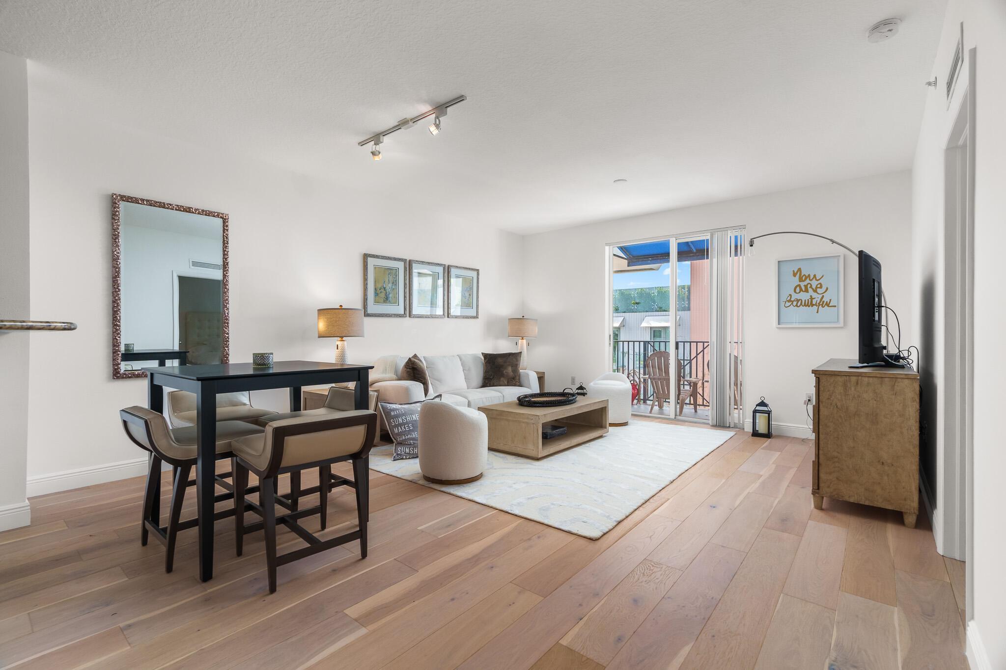 Welcome to this 5th-floor condominium available for rent in Pineapple Grove Village, located in the heart of downtown Delray. It is also available for a 6-month lease at $4,000 per month. This unit offers comfortable, updated living in a prime location.The condo has been refreshed with new paint and features engineered hardwood oak flooring, creating a warm and inviting space.Step out onto the western-facing balcony and enjoy the natural light that fills the living area. Pineapple Grove Village offers convenient amenities, including a gym, cardio rooms, saunas in the men's and women's locker rooms, a community pool, a business center, a yoga room, and a gated parking garage with one assigned spot.
