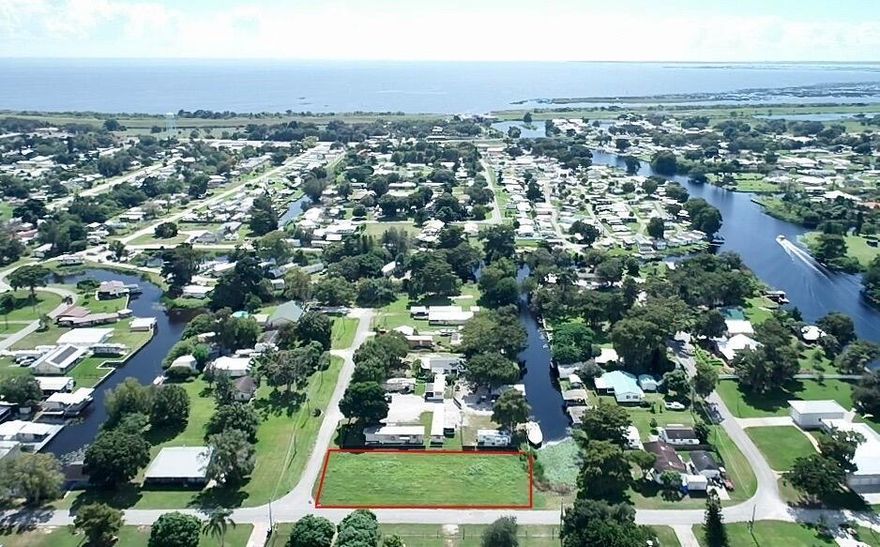 Lake Okeechobee Access! Located about 1/2 mile from the lake in the quiet neighborhood of Taylor Creek Development. This large .32 acre lot on city water comes with Survey. Zoned to build custom, modular or manufactured home with enough room for boathouse! Not many large buildable lake access lots available.