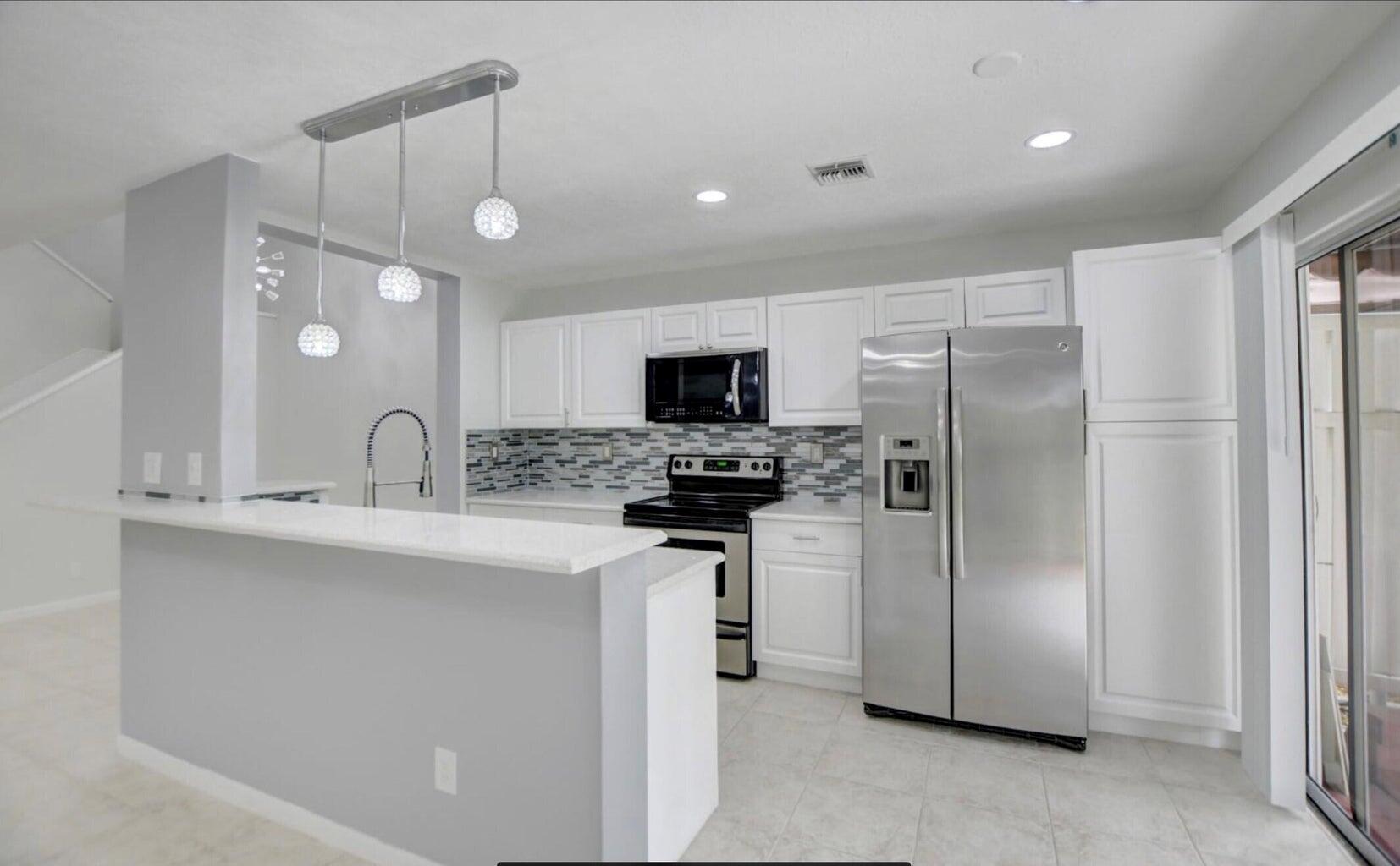 RESORT LIVING IN DESIRABLE Fairfield at Boca Raton, RENOVETED UNIT! Move in to stylish, meticulously renovated 3/2.1 townhouse. Prestigious gated community, best location in Boca, close to Town Center, restaurants and shopping areas. Don't miss living in PARADISE! Enjoy green, foliage landscaping, 2 pools, 2 tennis courts, handball and Basketball. Best school zone, bus stop for school inside the community. Spacious open floor plan with 3 primary suites and vaulted ceilings. Gorgeous private patio. DIMMING AMBIANCE LIGHTNING. Full size Washer and Dryer. Kitchen with QUARTZ countertops and STAINELSS STEEL appliances, TILE and HARWOOD floors. All measurements approximate; renter to verify.