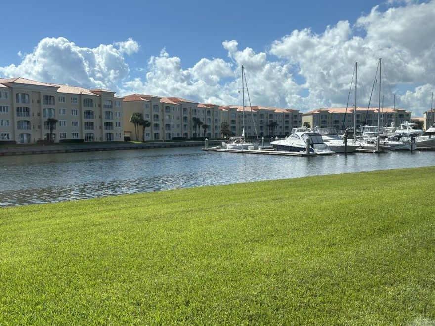 This stunning first floor unit has been completely upgraded, including kitchen and guest bath! You will love the seller's vision featuring travertine marble throughout (yes even the A/C closet!) crown molding, wainscoting, all newer appliances and newer washer/dryer, water heater and A/C too! Walk outside your Fla Rm impact sliding doors and enjoy boats and yes dolphins too! The Guest bedroom/bathroom has been upgraded to an ensuite bath with the entrance from the foyer directly into the guest bedroom suite! Plantation shutters, motorized shade in Fla Room, open kitchen upgrade, custom shaker cabinets, pull out drawers, soft close, and a built-in buffet too! List of all upgrades and check out ''What we love about our 1st FLOOR home...in Documents!HOA pays Cable TV, Wi Fi, Water & Sewer!