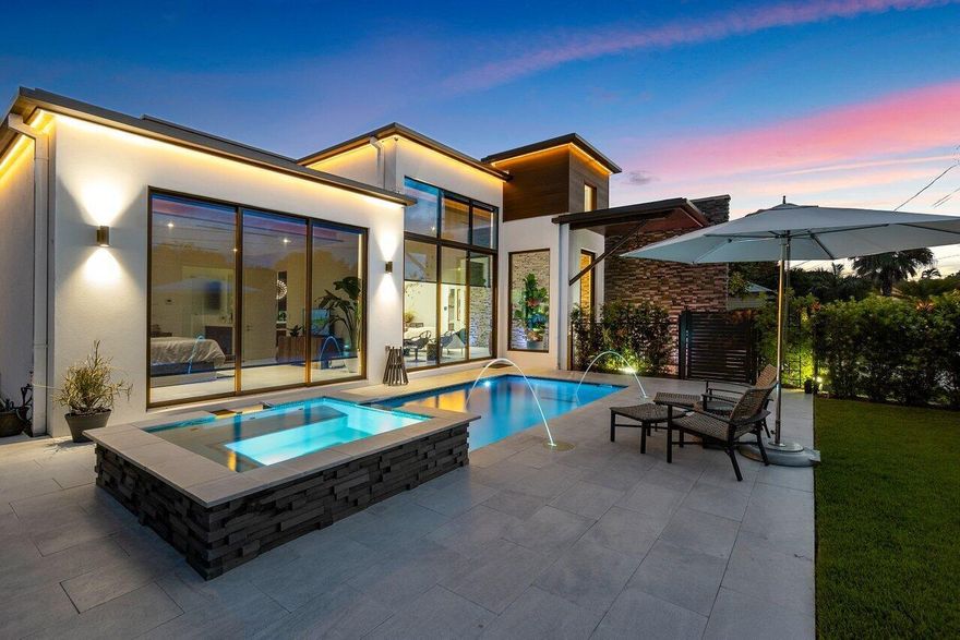 Welcome to 110 Wood Lane, an exquisite modern showpiece showcasing stunning architectural design and luxurious finishes. This remarkable home, was one of the last homes created by the late renowned architect Rick Brautigan, stands as a testament to his visionary talent and attention to detail. Nestled on cul-de-sac, on a meticulously landscaped lot, the residence exudes elegance and sophistication. Shell construction was by Hobt Contractor Services who pride themselves on quality foundation construction. The interior gut walls are concrete block which ensures strength and durability. As you step inside, prepare to be captivated by the abundant natural light that floods the living spaces, thanks to the impact and insulated windows by ES Windows.