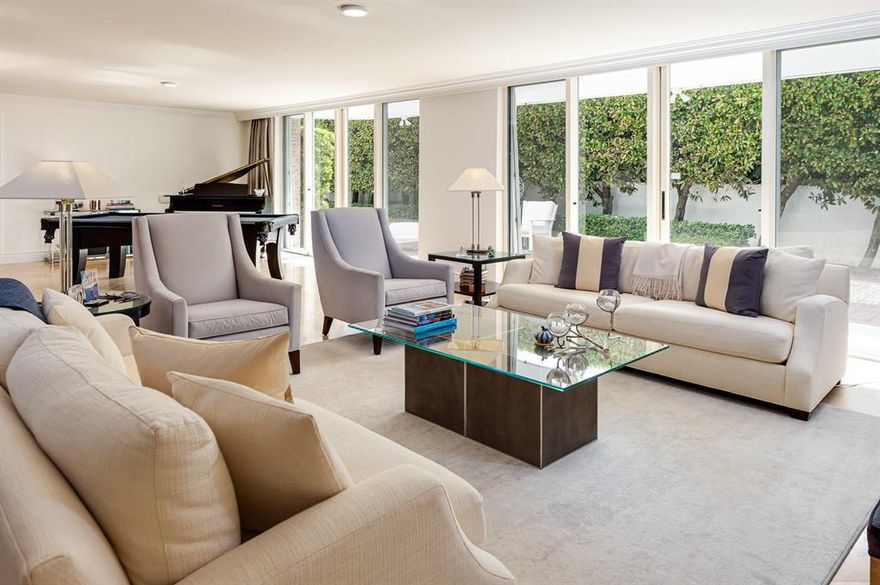 Rare, large PET Friendly 4Br, 3.5Ba home plus an elegant wood paneled office.  All rooms are bright, airy and open to a hedged and walled private garden/yard than runs 87 feet along the length of the apartment. Two master suites with oversized walk in closets, 2 additional bedrooms and abundant storage within the apartment. Expansive kitchen with peninsula, pantry storage and 2 dishwashers. 2 garage parking spaces - no elevator or lobby required to enter this unit.  White glove secure doorman building, sun deck, beautiful pool and tunnel to the beach. One of a Kind in prestigious  oceanfront building in the heart of Palm Beach.