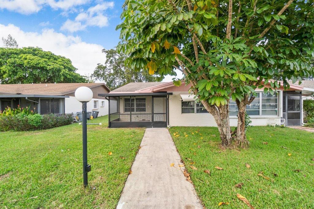 This villa is what you have been waiting for! Completely redone, on the water and low HOA fees, all in gorgeous Delray Beach. This villa features a front and back enclosed, screened in porch, with a storage closet and overlooking a serene lake. This corner unit has been outfitted with top notch tile flooring, open kitchen with white shaker cabinets and quartz counter tops. The wall has been taken down in the kitchen to create a more open space for entertaining. Tankless hot water heater and stainless steel appliances. The home also features brand new bathrooms with sleek modern finishes and new baseboards, crown molding and brand new paint throughout. Additional hi hats have been installed in the kitchen area. This unit shows beautifully and includes a den too!