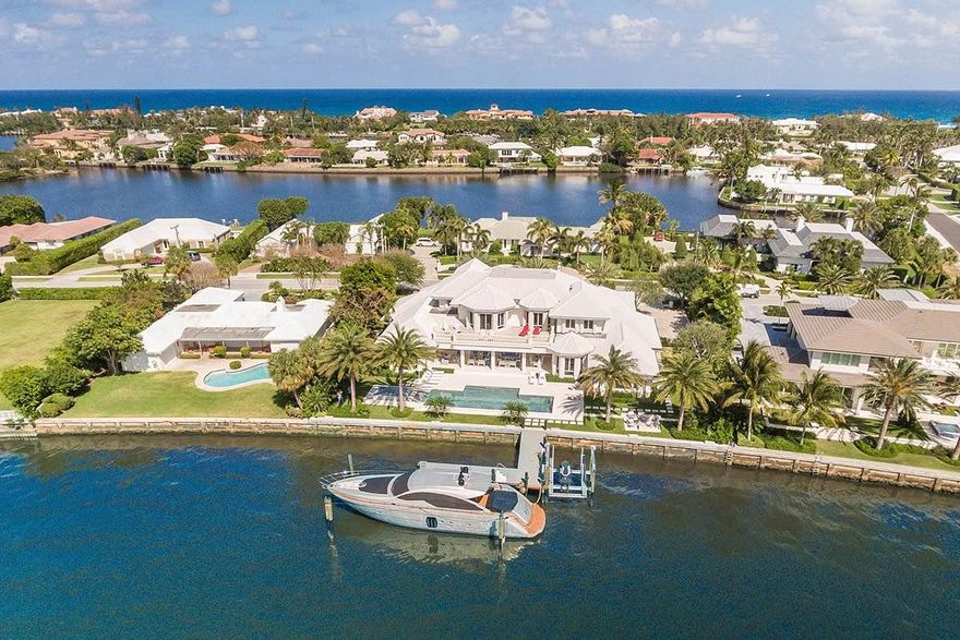 Experience stunning panoramic Intracoastal waterfront views from this expansive estate. Enter through the grand, light-filled two story foyer to discover direct water views, elegant architectural details and designer touches. The open and very spacious floor plan encourages the easy flow of conversation between the elegant living room and adjacent dining room. Each enjoy long water views across the Intracoastal. The sleek gourmet kitchen features a large central island with plenty of seating, state-of-the-art appliance and a lovely breakfast area. Marble flooring unites the main living areas.

On the second floor, sit back and take in the panoramic views from the 1,300 SF master suite with his and her baths, a freestanding bathtub, dressing areas and an expansive private terrace. Experience stunning panoramic Intracoastal waterfront views from this expansive estate. Enter through the grand, light-filled two story foyer to discover direct water views, elegant architectural details and designer touches. The open and very spacious floor plan encourages the easy flow of conversation between the elegant living room and adjacent dining room. Each enjoy long water views across the Intracoastal. The sleek gourmet kitchen features a large central island with plenty of seating, state-of-the-art appliance and a lovely breakfast area. Marble flooring unites the main living areas.

On the second floor, sit back and take in the panoramic views from the 1,300 SF master suite with his and her baths, a freestanding bathtub, dressing areas and an expansive private terrace. With a study, gym, and billiards room, you'll never have to leave home! 
The resort-like backyard is perfect for entertaining. The expansive covered lanai features coffered ceilings and infinity screens. Lounge areas by the sparkling heated pool and spa and a waterside fire pit beckon you to relax. A dock with a 14,000 lb boat lift completes this estate.  Includes gratis membership to the La Coquille Club at the EAU Palm Beach.