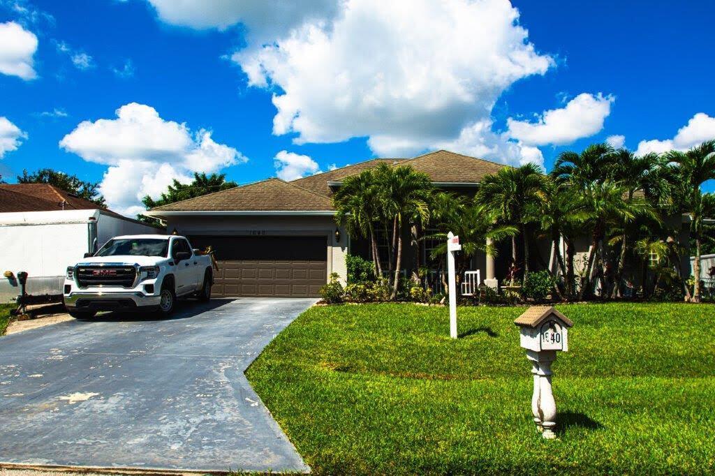 This amazing single family home sits on a quiet street of Port St Lucie neighborhood, just a couple blocks from shopping, dining, parks, churches also with an easy commute to I95 and FL turnpike. The property features vaulted ceiling, master suite, beautiful laminated wood flooring, formal dining area and family room. The spacious eat in kitchen has plenty of cabinet space with granite counters and such a beautiful rear porch to entertain friends in a Florida lifestyle.
