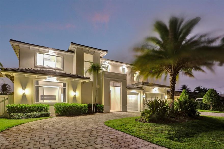 Stunning coastal-inspired estate in highly desired Lighthouse Point just minutes from the Hilsboro Inlet. This 2017 built, meticulously designed 5 bedroom, 6 bathroom home impresses with a bright, open-concept floor plan as well as uncompromising quality and craftsmanship. The chef's kitchen features coastal elements, Bosch appliances, custom cabinetry and more. The living room with aw-inspiring floor-to-ceiling sliding glass doors leads to an expansive outdoor area with integrated summer kitchen and a tranquil pool with sun shelf entry. The luxurious oversized owner's suite offers a bright and airy feel with panoramic pool and water views. Truly a boaters dream with a full-service 85 foot, deepwater dock. Move in ready with Cat 6 wiring and fully furnished with exclusive European pieces.