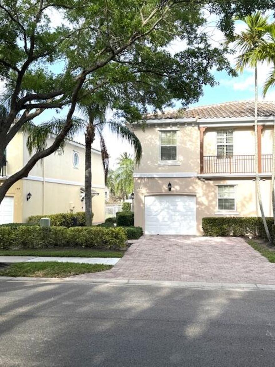 Beautiful Townhome in the center of Palm Beach Gardens with easy access to dining, beach, Interstate travel and PBl Airport.  This Divosta built townhome has poured concrete walls with New Roof (2023). The kitchen boasts granite countertops, stainless steel appliances and New Wine Refrigerator.  The large screened-in courtyard patio has LED lighting with beautiful lake views.  The expansive primary bedroom has two large closets, double-sink master bath with shower and soaking tub.  The one-car garage has ample room for mid-size vehicle and storage.  This maintenance free townhome has many new upgrades including new tile floors on staircase and second floor, new Kitchen and Laundry Room Backsplash, all new ceiling fans, new Ring Cameras, Electrical surge protector and generator hookup.