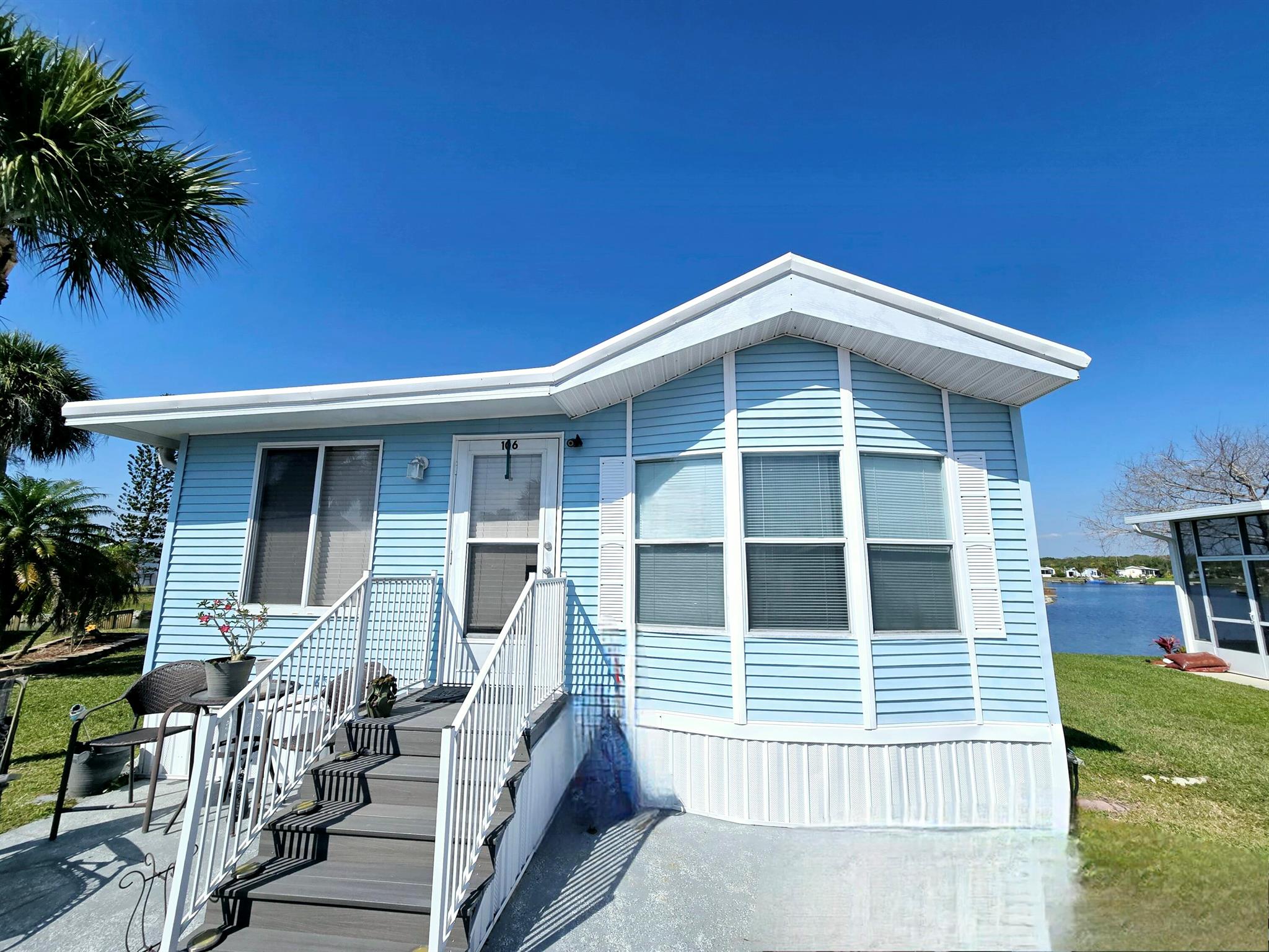 Blue Cypress Golf and RV Resort 55+ community with a golf course. This 2 bedroom 1 bathroom features an open floor plan with large living and dining area. Very well kept, move in ready. Enjoy your afternoons overlooking the water. This community offers lots of great amenities including pickleball, community pool, clubhouse and a 9 hole golf course. This park is very well maintained and the hoa fee covers trash, lawn care and water and sewer.