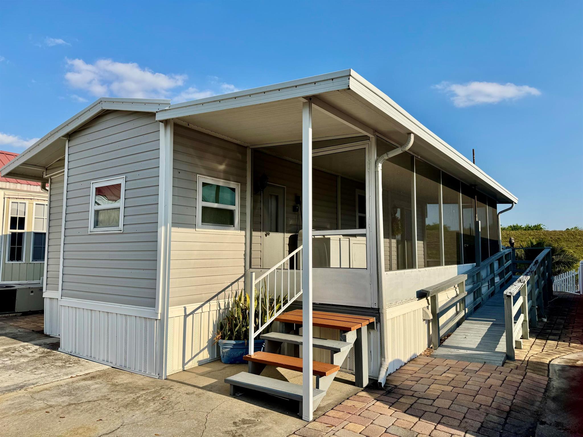 BIG ''0'' Waterfront Living! 1 Bd/ 1 Ba Park Model with full length screened patio. Handicap accessible with ramp and steps. Roomy living area, fireplace, lots of storage and dining for two! Newer windows, siding and metal roof. Pavers everywhere including party patio on the water. Even an anchor pole for your boat. Lake''O'' access. HOA-135/mo. Community pool, activities, 55+ lifestyle. This SWEET home could be yours!Dimensions are approximate, must measure for exact.