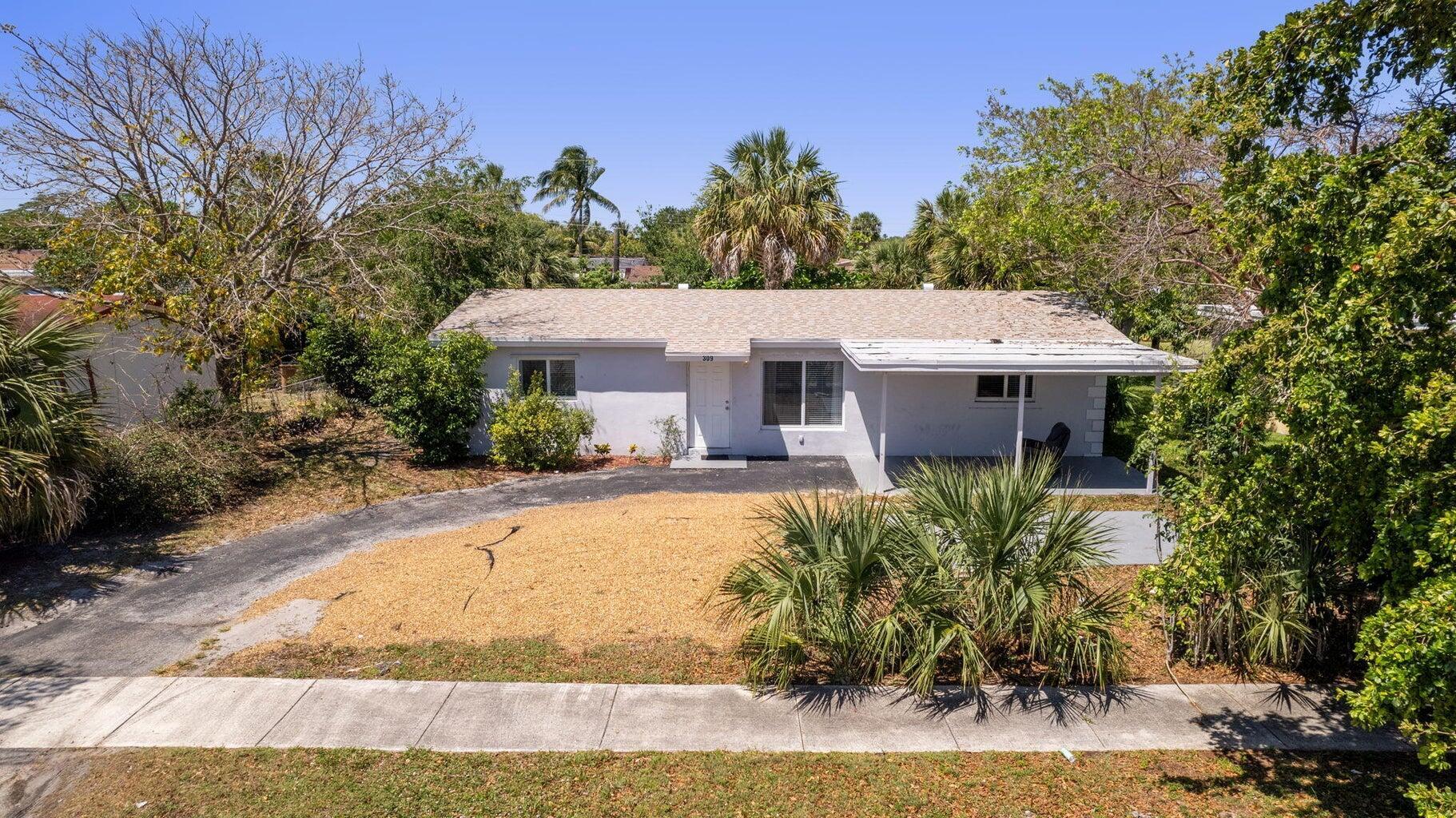 This stunning 4/2 home boasts an open floor plan that creates a welcoming and spacious ambiance. The upgraded kitchen and bathrooms feature modern fixtures and finishes. The two-year-old roof and new impact windows ensure peace of mind and energy efficiency, while the new plumbing and water heater provide reliability and convenience. The large driveway offers ample parking, and the spacious yard provides plenty of room for outdoor activities/relaxation. Situated close to pristine beaches and major highways, this home offers the perfect blend of tranquility and accessibility. Enjoy the freedom to customize your living space to your liking. Don't miss out on this exceptional opportunity to call home, great location. Perfect for a family