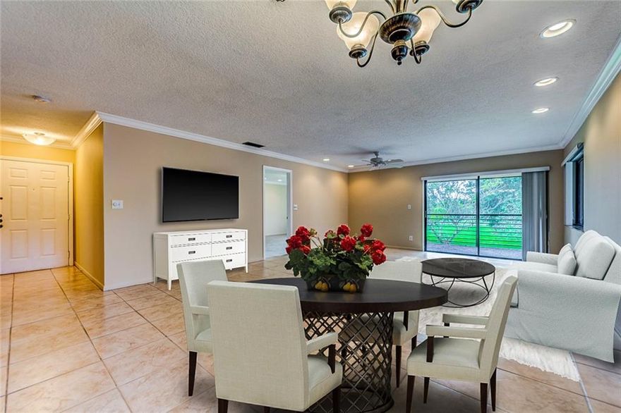 ALL AGES WELCOME! Near colleges! The Gardens is BY FAR the best community in Pine Island Ridge.  4 units per building, each is a corner unit.  Ample guest parking.  This garden style apt has tile, an oversized living/dining room combo, a split floorplan and an AMAZING view from huge screened in patio with incredible breeze. Perfect for a bistro table, hammock, or outdoor dining set. Crown molding throughout. Updated high hats.  This Master bathroom has been totally remodeled with fresh new tile, shower and vanity.   Master Bedroom is huge! It has it's own exit onto the patio. Natural light abound.  Brand new carpeting as well as high hat lighting.  Amazing kitchen with solid wood cabinets with eat in nook and washer/dryer in the unit. Great amenities include gym, pools, sauna,restaurants.