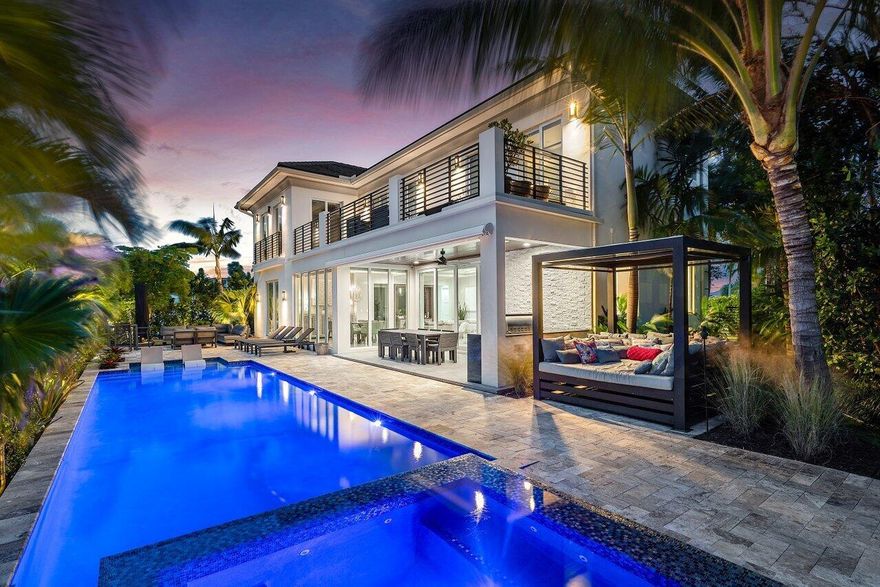 This stunning designer estate, completed in 2019, offers the ultimate luxury waterfront lifestyle in Tropic Isles, Delray Beach's premier boating sanctuary. Perfectly situated on an expansive corner lot with over 100 feet of prime water frontage, this property offers an exclusive 80-foot dock, catering to serious boating enthusiasts who value both convenience and elegance. Inside, over 4,452 square feet of sophisticated living space showcases unparalleled design and luxurious materials throughout. The residence includes spacious en-suite bedrooms, each with custom finishes, as well as an office or library that could also serve as an additional bedroom, complete with its own private bath. In total, there are five full baths, a powder room, and a private elevator, seamlessly...