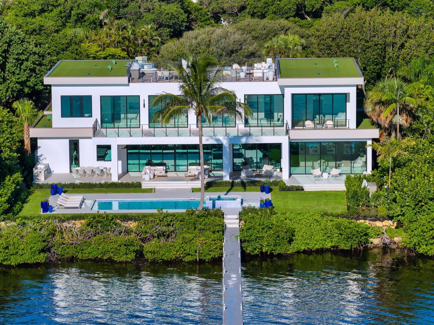 Welcome to 1422 SE Atlantic Drive, a rare opportunity to own one of the most prestigious newly completed residences on Hypoluxo Island, near Manalapan. This stunning waterfront estate, crafted by the renowned Farrell Building Company, one of the nation's leading ultra-luxury homebuilders, epitomizes modern elegance and South Florida living at its finest. Set on a sprawling half-acre parcel with 120 feet of direct waterfront, the home offers breathtaking views of the Intracoastal Waterway and some of the most iconic estates in the world, including the illustrious Manalapan Ocean-to-Lake properties.