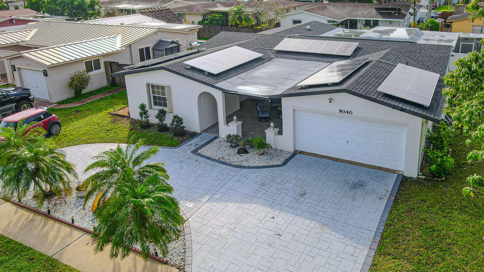 Step into a realm of comfort and sophistication with this stunning 4-bedroom, 2-bathroom pool home, complete with a spacious 2-car garage. Before entering, you're welcomed by a large open porch, ideal for a sitting area, lounging, or relaxing with your favorite book or beverage. Inside, the open, airy layout features a formal dining area, and an inviting living space adorned with elegant marble flooring, creating a luxurious yet welcoming atmosphere.The heart of the home is the expansive kitchen, designed for culinary inspiration. Pristine stainless-steel appliances, granite countertops, decorative under-cabinet lighting, and refinished cabinetry combine for a sleek and modern aesthetic. Flow effortlessly into the oversized family room--an entertainer's dream!