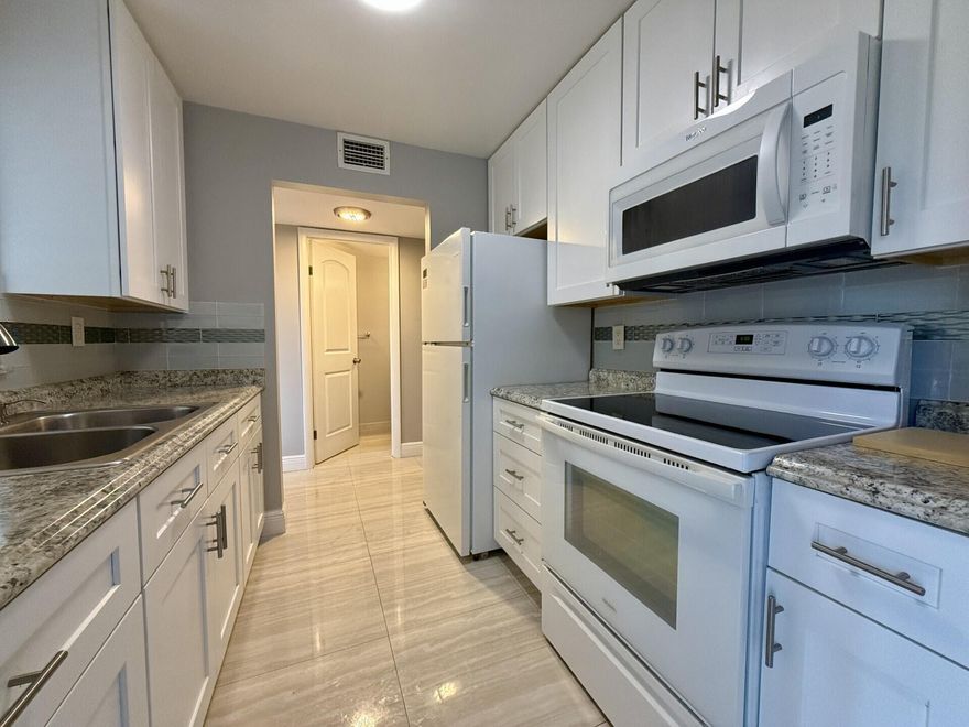 Stunning, 1st floor unit with your own private patio paradise. This amazing unit features gleaming, ceramic tile floors, updated kitchen and baths and central air conditioning. A washer and dryer in the hall closet completes this wonderful unit. Spacious Bedroom Suite With Wall of Closets and Full Ensuite Bath. Complete hurricane shutters for your protection. Freshly painted & ready for you to enjoy all that Century Village has to offer! Century Village Is A 55+ Community with So Much to Offer..