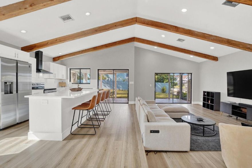 This home offers everything you are looking for. From a large yard with outdoor patio to a dock for your 19 ft boat to navigate Lake Ida and the surrounding waterways. Pets are welcome! Impact windows, beautiful remodeled kitchen, open concept, two car garage, and a gated community that offers pool, tennis courts/pickle ball, basketball, miles of walking trails. 3 miles from the beach and popular Atlantic Ave.