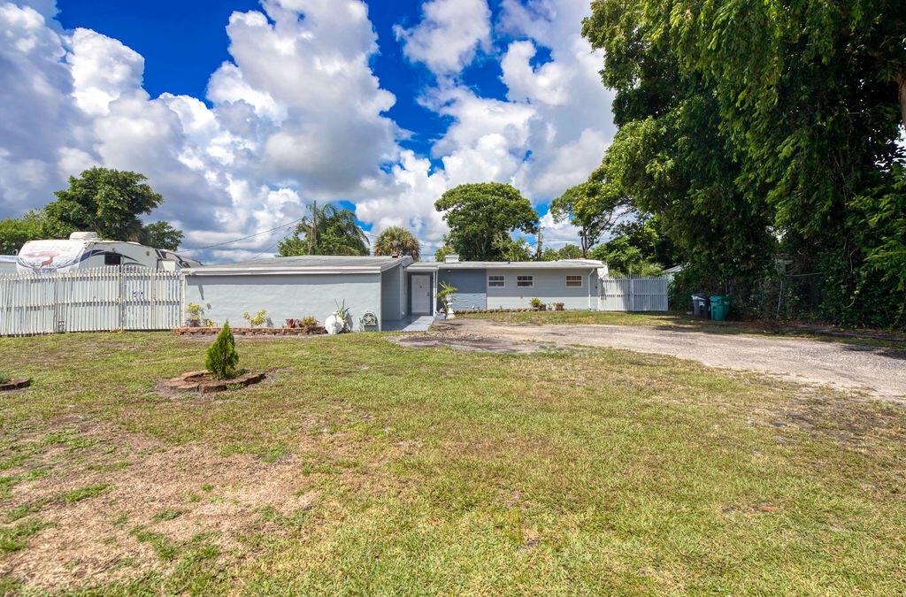 Beautifully updated 3-bed, 2-bath CBS home with laundry and carport in a quiet, family-friendly neighborhood. The large kitchen boasts white quartz countertops and modern cabinets. Features a spacious open layout with views of a lush tropical backyard filled with mango, tamarind, and other fruit trees. Plenty of room for a boat, RV, or future pool. Beautiful porcelain tile flooring throughout. Updated A/C, appliances, and water heater. Freshly painted inside and out. Conveniently located near schools, shopping, restaurants, and banks--perfect blend of comfort and accessibility!