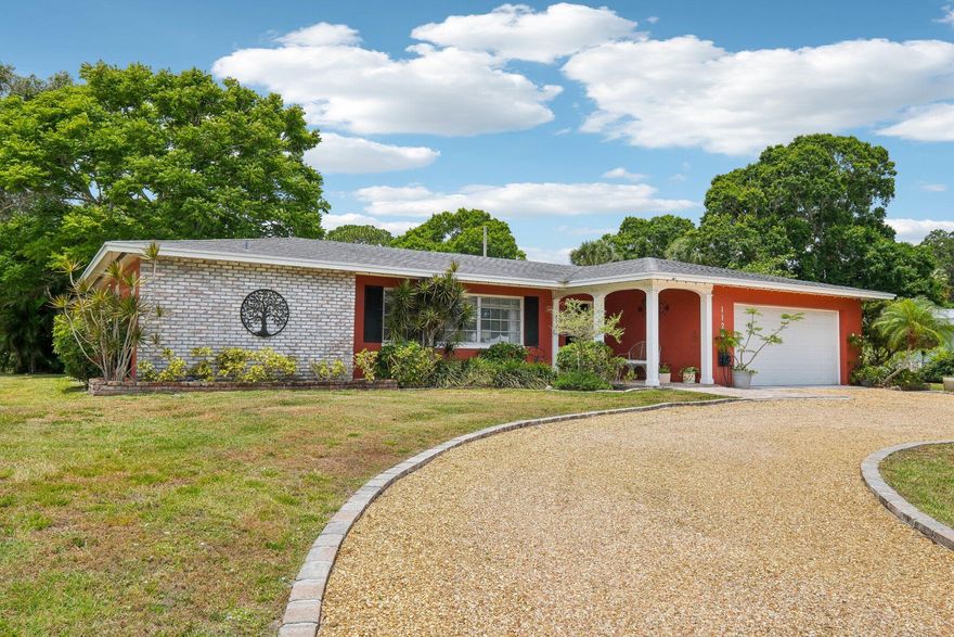 Perfectly located and within minutes to beaches and shops, this spacious 2/2 features tile floors, completely remodeled kitchen and primary bath, large Living room and attached family room Family room, with sliders to patio from both. A spacious split BR plan, this home has amazing entertaining flow. The 2nd BR is a 2nd Primary. Enclosed lanai has outdoor kitchen/grill area, irrigated garden within, and potting area, and views of garden behind home. Newer metal roof and central air conditioning plus a bonus of enclosed office room within garage with separate entrance. Very well maintained.