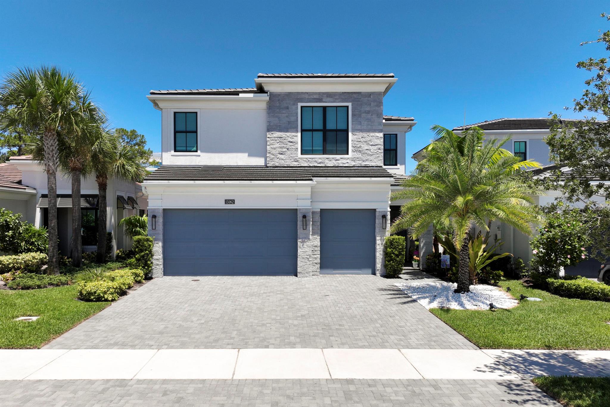 MOVE-IN READY & STUNNING! This 2-story masterpiece in Artistry offers 4 Bedrooms + Den + Loft, 3.5 Baths, and a 3-Car Garage -- all overlooking gorgeous preserve views from your private Lanai. The designer Island Kitchen will impress with sleek cabinets topped with crown moulding, striking quartz countertops & backsplash, a 30'' built-in oven, 36'' Monogram cooktop, and a wall-mounted hood. The open Family Room's expansive sliding glass doors flood the home with natural light, creating an airy and inviting atmosphere.Upstairs, all bedrooms and the spacious Loft with tray ceilings await. The Owner's Suite is a private retreat with triple windows, tray ceilings, and a spa-like bath featuring a frameless walk-in shower with seat, dual vanities, and two walk-in closets.