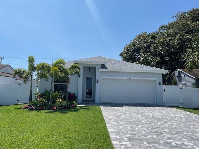 Beautiful brand new construction in the heart of WPB. Spacious 4 BR/2 Bath home w 2 car garage, open kitchen, cathedral ceilings, impact windows & modern designer touches. Large walk in closet in main bedroom & rear covered patio sitting area.