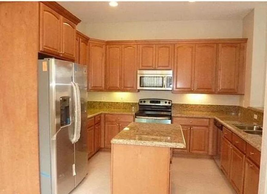 Spacious and beautifully updated townhome featuring 3 bedrooms and 2 full bathrooms. The modern kitchen is equipped with marble countertops, stainless steel appliances, and ample cabinet space, perfect for everyday living and entertaining.All three bedrooms are located upstairs, including a primary suite that boasts a luxurious en-suite bathroom with a Jacuzzi-style soaking tub and a walk-in shower. Enjoy outdoor living with a private balcony and a fenced backyard, ideal for relaxation or family gatherings. Located near Coral Springs High School, this home is perfect for medium-sized families seeking comfort, convenience, and style.