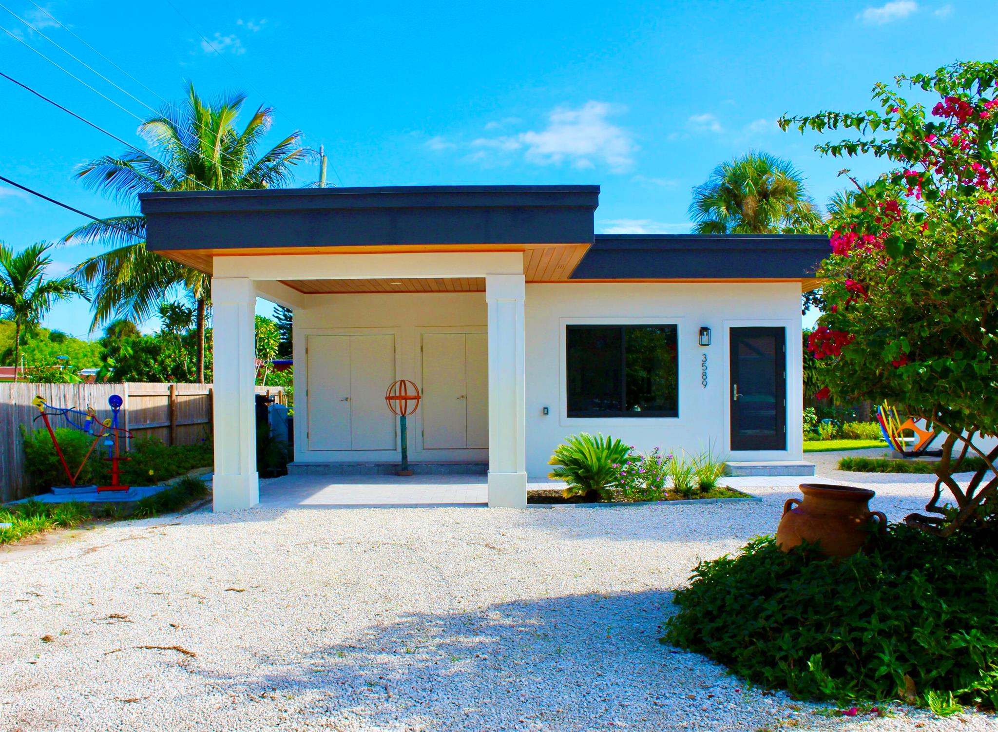 Modern single-family home built 2021. Located near downtown Delray Beach in quiet historical neighborhood near US1/Federal Hwy & Beaches. Large open kitchen and spacious floor plan for a with private washer & dryer. Everything new 2021! Front covered patio & back patio. Hurricane impact windows & doors. High ceilings with recessed lighting! Custom roll-down shades. 24x24 tile wall-to-wall. New appliances, central air-conditioning, instant tankless hot water system, serene lush landscaping with exterior artwork throughout, whole house water filtration system, off-street parking for 2 cars. Quiet serene area. No HOA! Quick Approvals! Water/sewer included in rent. Pet-friendly