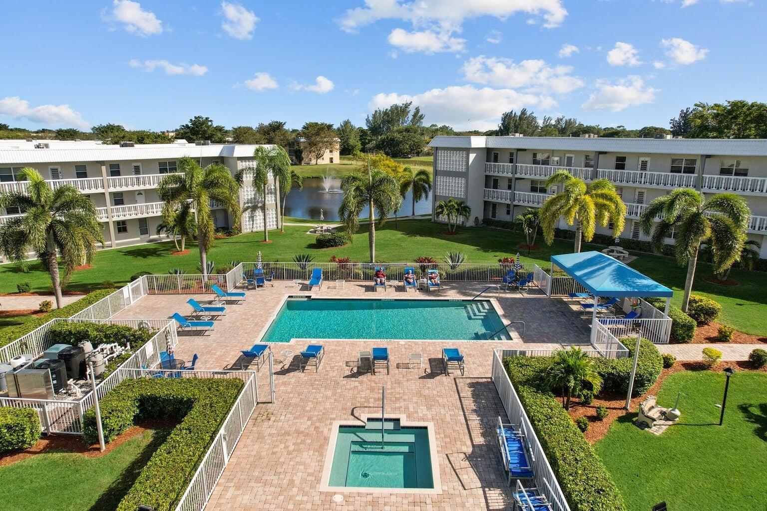Welcome to this charming 2-bedroom, 2-bathroom condo nestled in the serene community of Sandalfoot. This inviting residence boasts neutral flooring and smooth walls throughout, creating a canvas ready for your personal touch. The open floorplan seamlessly connects the spacious living area to the kitchen, which features classic white cabinets and a convenient pass-through to the dining area. Enjoy casual dining in the cozy breakfast nook or entertain guests in the elegant dining space. The primary suite offers a tranquil retreat with his and hers closets and an en-suite bath for added convenience and privacy. Step outside to the screened balcony and soak in the picturesque lake view, perfect for relaxing mornings or evening gatherings.
