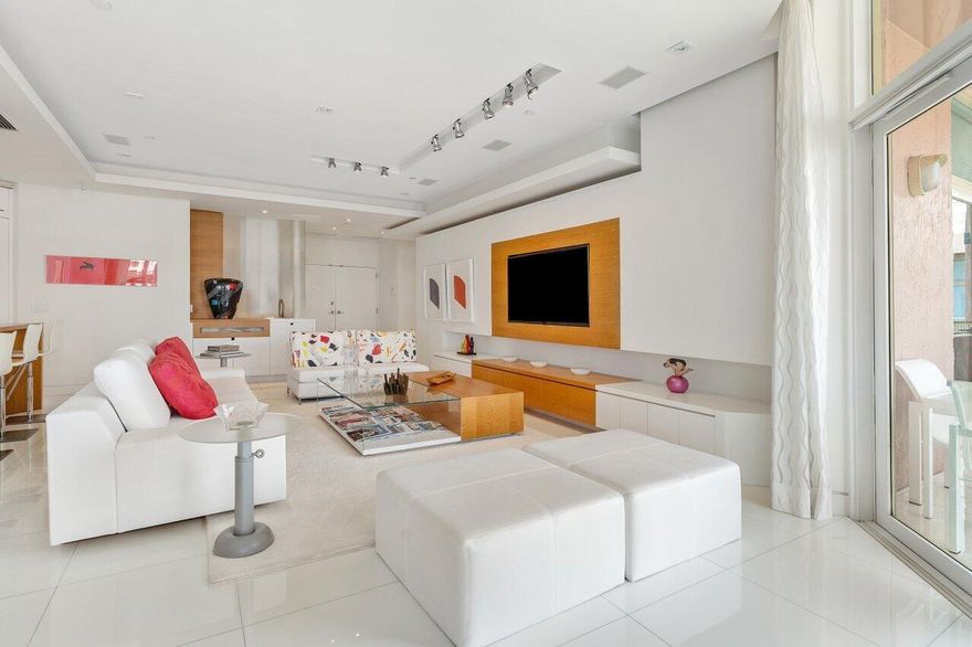 Experience the epitome of modern luxury in this completely renovated 3-bedroom, 3.5-bathroom waterfront penthouse in the newly updated Mizner Tower Condominium directly on Lake Boca Raton, adjoining The Boca Raton Resort and Beach Club. The sophisticated design of this unit offers a seamless fusion of architectural details and top-notch finishes, featuring a European kitchen with white and stainless cabinets, quartz countertops, and  Miele and Sub-Zero appliances. The main living area has a wet bar, and a 'Greenhouse'' area where the tall ceiling allows natural light to pour in. Throughout the home, warm woods, marble, quartz, and other natural materials accentuate the architectural details, creating an atmosphere of timeless elegance. The spacious unit has 2465 sq. ft and a wrap balcony