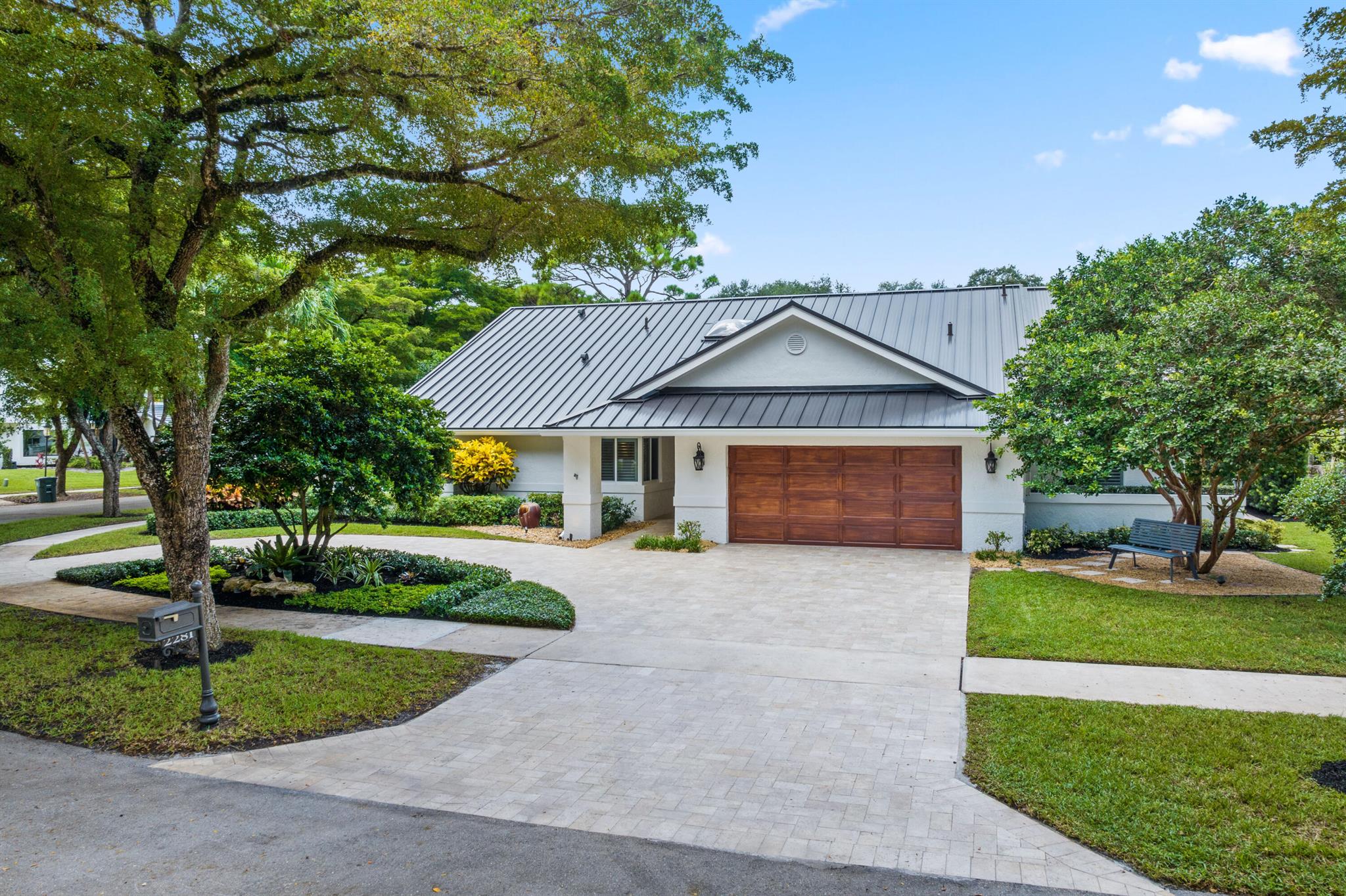 One of a kind! Nestled on a private cul-de-sac in the desirable Millpond community, this home truly checks all the boxes. Set on an oversized lot, it offers resort-style living and the ultimate Florida lifestyle. Featuring 4 bedrooms, 3.5 bathrooms, and a 2-car oversized garage, the home boasts a brand-new 2025 metal roof, impact windows and doors, and freshly painted interior and exterior.No expense has been spared, from lush landscaping with custom lighting to an upgraded circular travertine driveway and an outdoor living area designed for entertaining. The tiki hut includes a full Paradise grill bar, pizza oven, outdoor TV, Sonos system, and furniture, all conveying with the sale. In addition, the heated saltwater pool shines with 2023 Diamond Brite finish, new turf area,