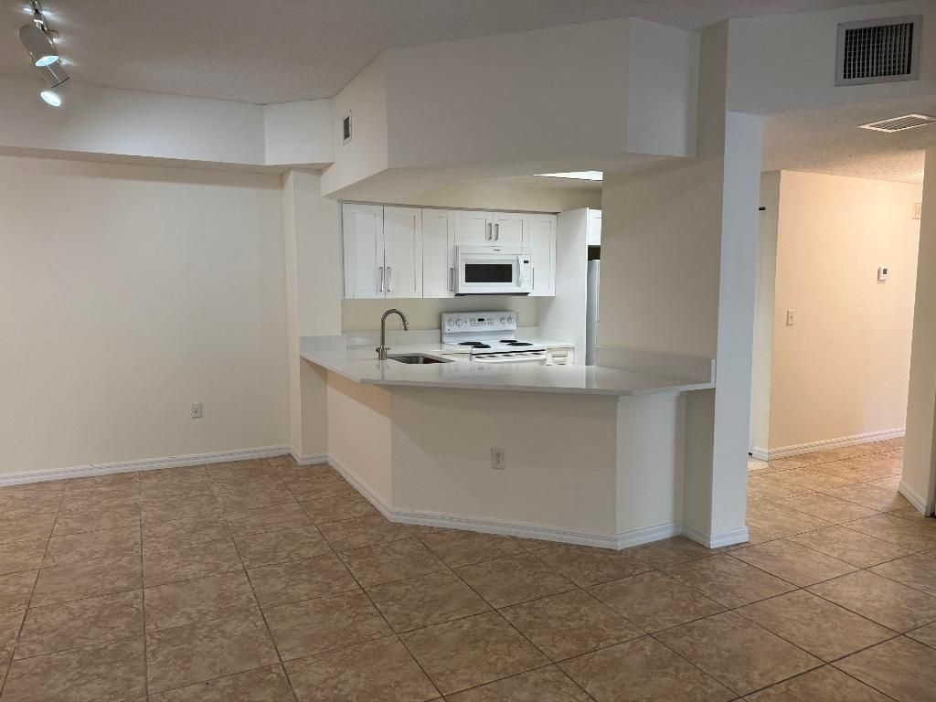 Photo of 3020 Alcazar Place #303, Palm Beach Gardens, FL 33410 (MLS # R11144946)