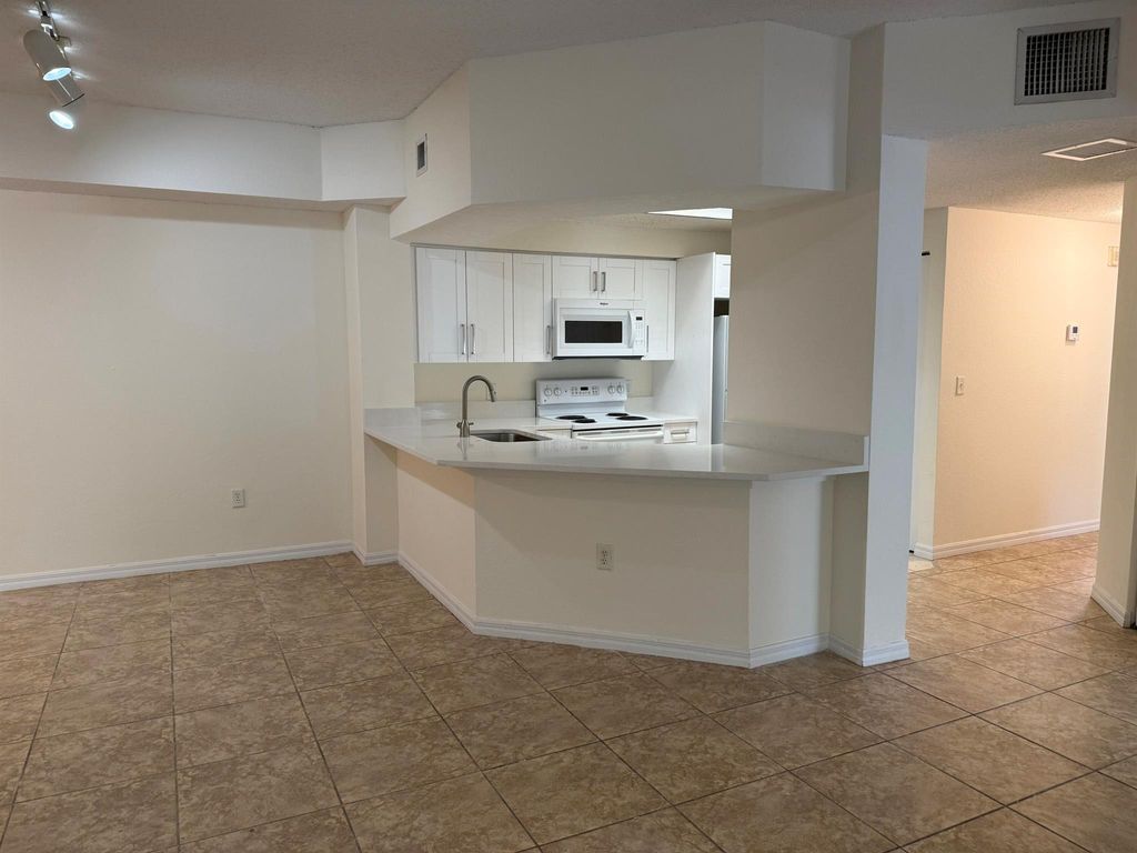 Photo of 3020 Alcazar Place #303, Palm Beach Gardens, FL 33410 (MLS # R11144946)