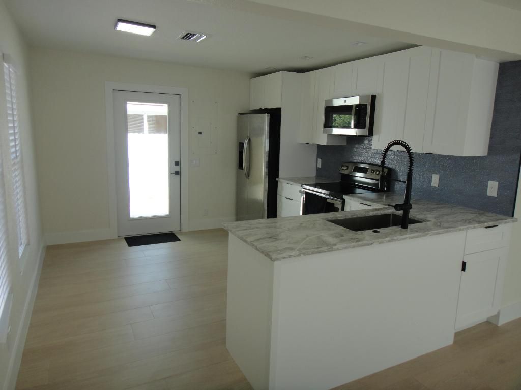 Photo of 717 Bunker Road, West Palm Beach, FL 33405 (MLS # R11157978)