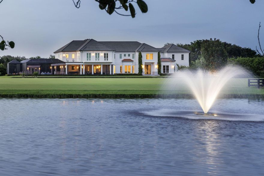 Nestled within the prestigious gated enclave of Palm Beach Point, just one mile from the world-renowned Wellington Equestrian Festival, this impeccable 23-acre estate represents the pinnacle of luxury equestrian living. Completed in 2023, the sprawling 11,000+ sq ft residence is a masterpiece of new construction, where no detail has been spared--from a state-of-the-art restaurant-grade kitchen to an extraordinary pool oasis featuring a zero-edge saltwater pool, oversized Jacuzzi, and innovative chiller system for therapeutic recovery. Equestrian excellence abounds with a pristine 20-stall center-aisle barn, dual tack rooms, commercial laundry, and expansive grooming and feed stations, complemented by an oversized all-weather arena, 14 lush paddocks, and a 3.3-acre Grand Prix field