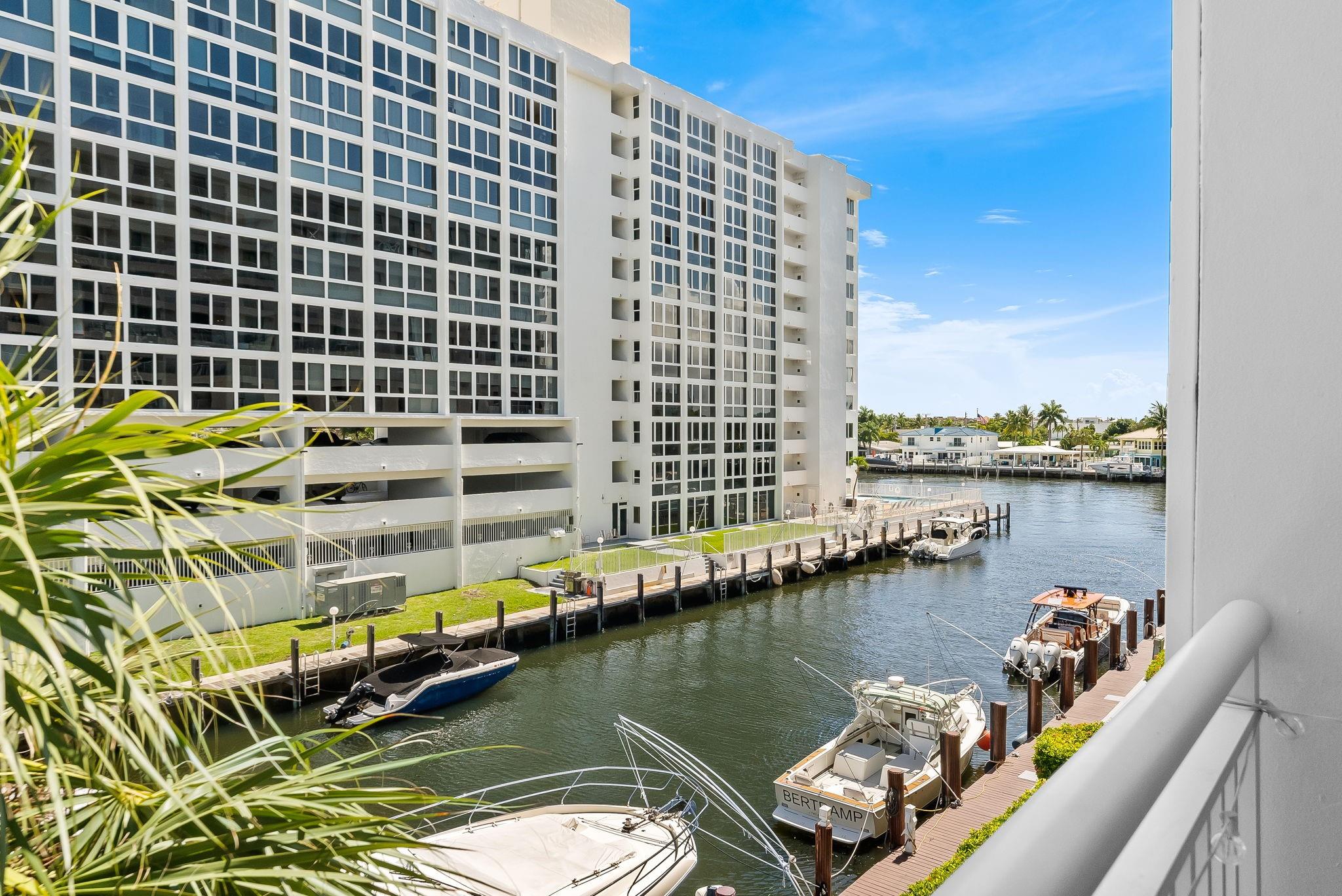 Nestled right off the intracoastal and just over the bridge to the beach, you don't have to go far to enjoy your new lifestyle! Rarely available and turnkey 3 bed/3 bath townhome in the highly coveted building of Pilot House. Open concept floor plan with soaring ceilings, great natural light, two fireplaces, porcelain wood plank floors downstairs and hardwood floors upstairs. Tastefully remodeled kitchen with JennAir appliances, Quartz counters, tile backsplash, new washer/dryer. Spacious primary suite has two walk-in closets, huge shower, soaking tub and dual vanities. Enjoy outdoor living on your front lanai or your balcony overlooking canal and intracoastal. Secured building w/heated pool, gym, pets allowed. 2 garage parking spots. Dock space $6/ft when avail. SIRS & 40 Yr complete!