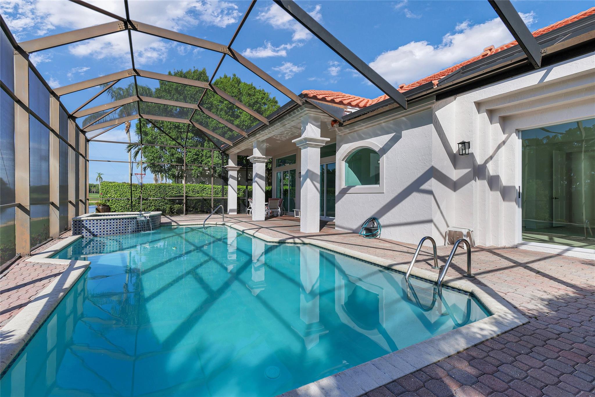 Highly sought-after "The Pointe" at Weston Hills! Located in a prestigious guard-gated golf course community, this spacious 1-story home features a large screened-in pool and spa with a covered lanai, offering the perfect outdoor escape. Enjoy tranquil water views of the canal and no rear neighbors, creating a private, peaceful setting for Florida living at its best.
Inside, you’ll find volume ceilings, walk-in closets, custom built-ins, and first-floor entry. The kitchen is fully equipped with a wall oven, electric range, microwave, dishwasher, and more. Enjoy community walking paths, lush landscaping, and included maintenance covering lawn care and 24/7 security. Turnkey potential and priced for your personal updates!