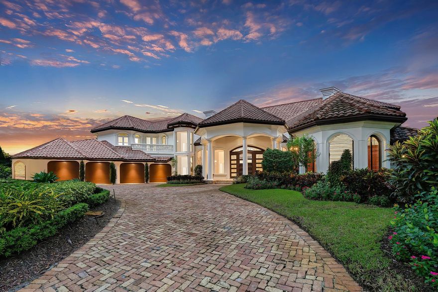 This refined Palm Beach-inspired masterpiece is situated on .62 acres with spectacular panoramic lakefront and golf course views. A graceful arched entry sets the timeless tone of this 5 bedroom, 6.2 bath residence with 9,211 square feet under air. The classic look is fashioned with custom architectural elements, exquisite designer finishes, marble and wood floors and stunning ceiling treatments throughout. The flow functions beautifully for entertaining with French doors to the outdoor living room, summer kitchen and luminous pool with spa and fountain in a relaxing resort-like oasis. Notable features of the home include the authentically designed theater, large family room, and primary grand suite with a luxurious bath and generous