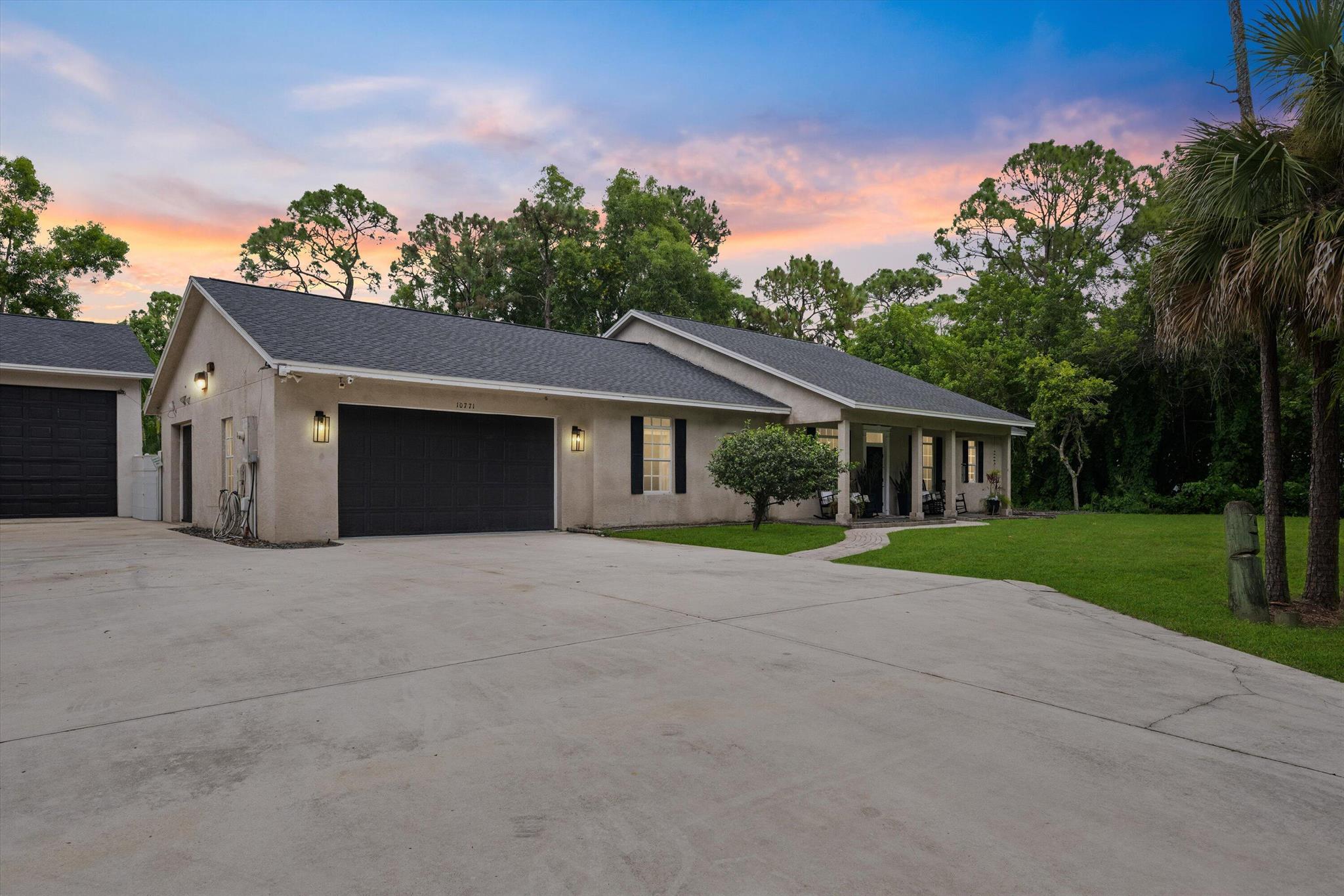 Jupiter Farms Living - Freedom, Space, and Privacy! Welcome to this beautifully maintained home offering a 3 bedroom plus office/4th bedroom, 2 bath main house and a detached oversized garage with adjoining 1 bedroom, 1 bath guest quarters on 1.5 private, fenced, and gated acres in highly sought-after Jupiter Farms, this custom home is designed for both comfort and functionality. Upon entering this home, you are welcomed into a foyer that opens to the living room with vaulted ceilings and triple sliding doors with views to the very private backyard. The kitchen is truly the heart of this home and blends seamlessly with the living and dining rooms. The chef's kitchen boasts a center cooking island with an abundance of solid wood cabinetry covered with reaches of countertops