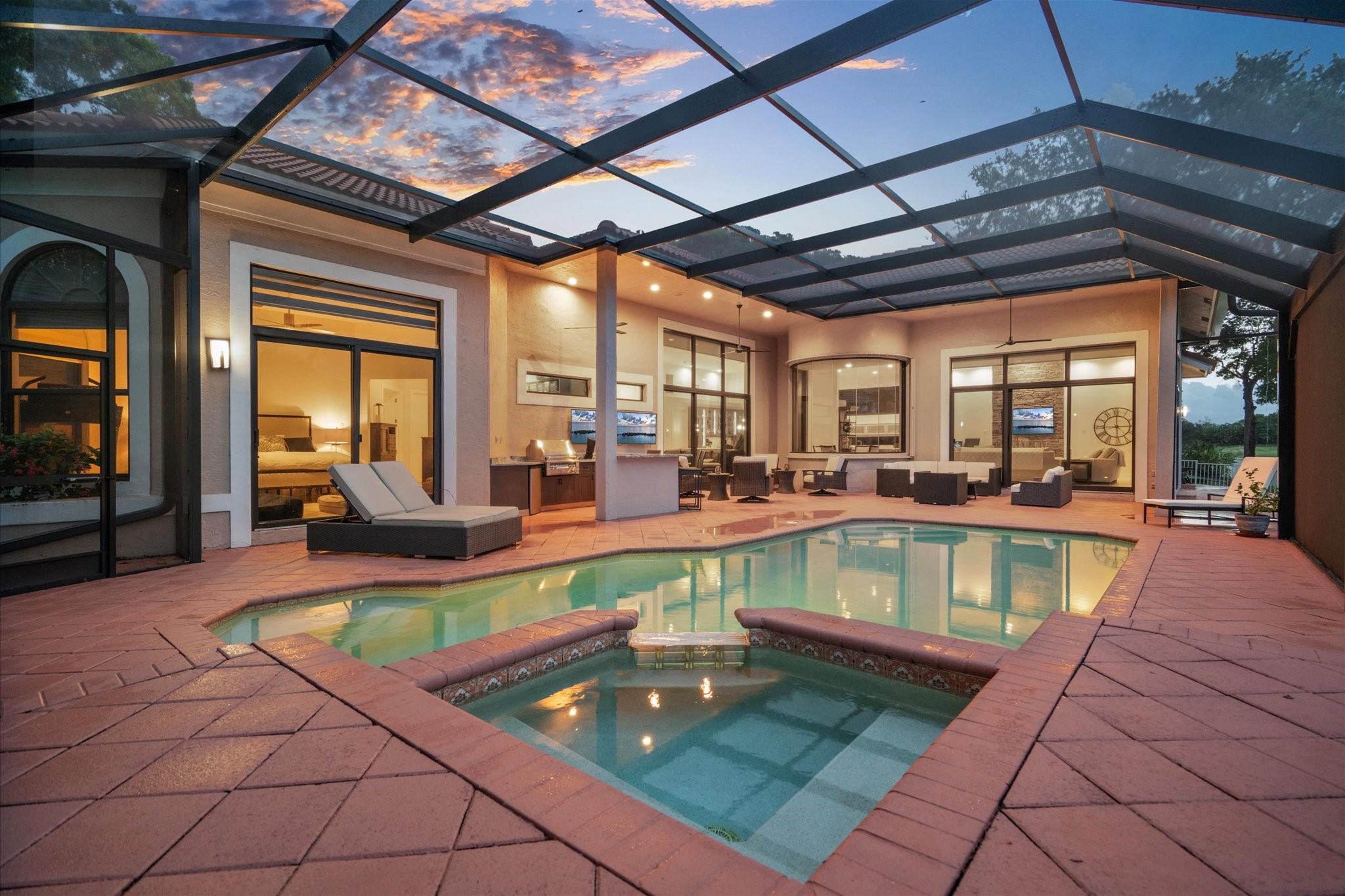 Stunning 4BR/4.5BA modern home in prestigious Eagle Trace with water and golf views. Features include high ceilings, impact windows and doors and LED lighting. The chef’s kitchen boasts JennAir appliances, a quartz island, and custom cabinetry. A large dining area is perfect for entertaining, & both the living and family rooms overlook the pool. The luxurious primary suite offers 2 custom walk-in closets and a spa-style bath with a floating vanity, soaking tub, and glass-enclosed shower. Enjoy a resurfaced saltwater pool, outdoor kitchen, high-end pool enclosure, new wireless sprinkler system, and updated landscaping. A newer A/C. Gated community with golf, tennis, and more. See feature sheet.